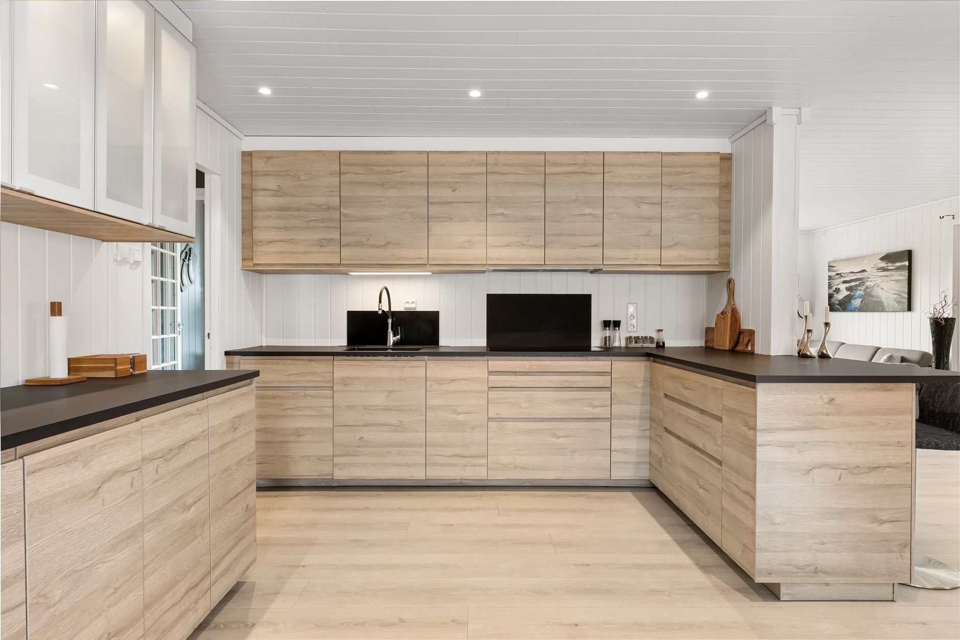 Contemporary flat-panel wood kitchen cabinets with dark stone countertops