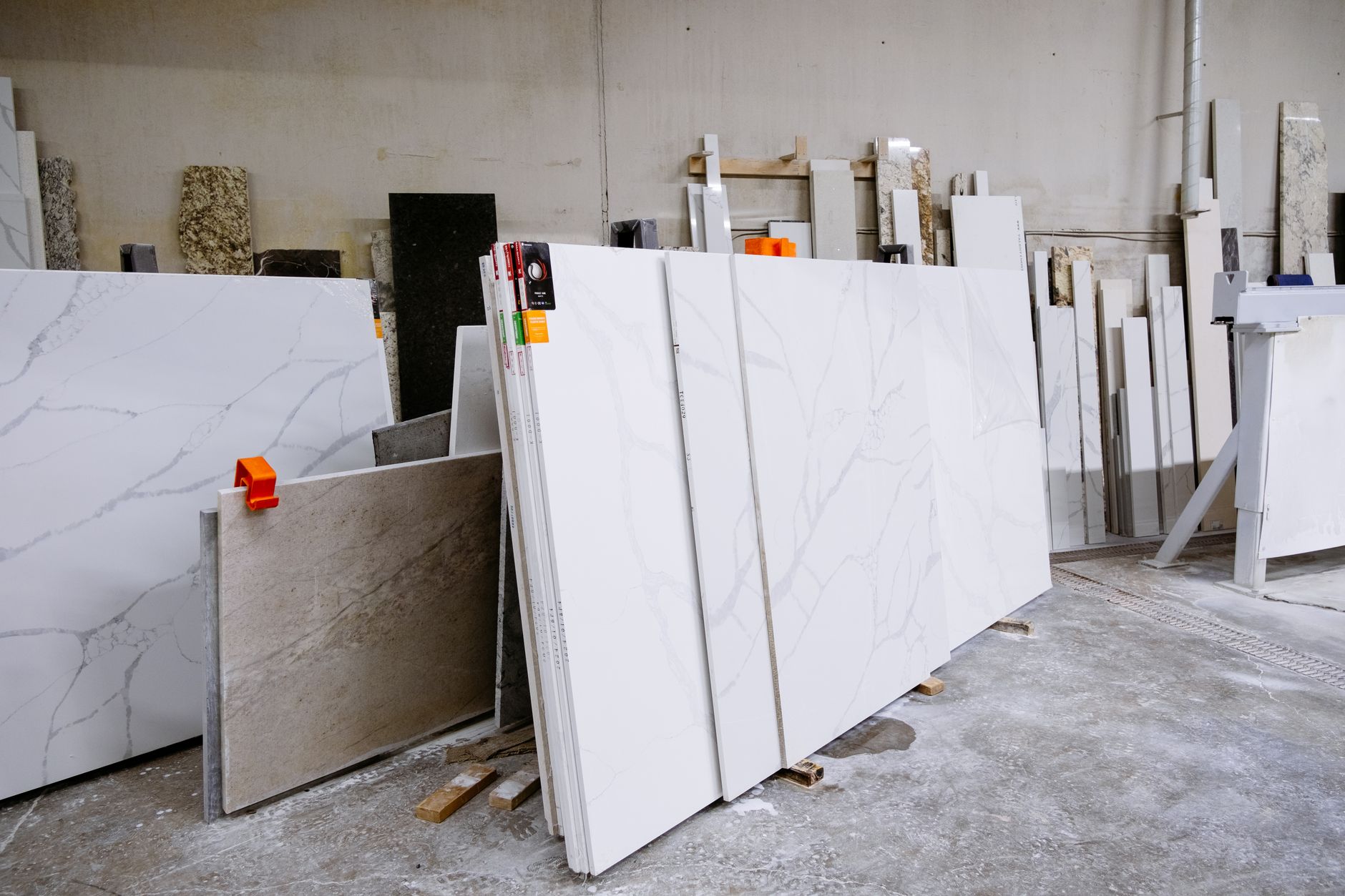 Natural stone slabs standing in a fabrication showroom